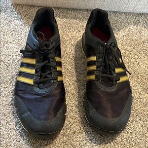 Adidas Men’s Black Athletic Cleats with Gold Stripes